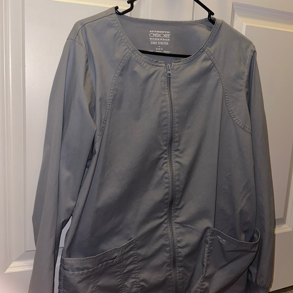 Grey scrub jacket.